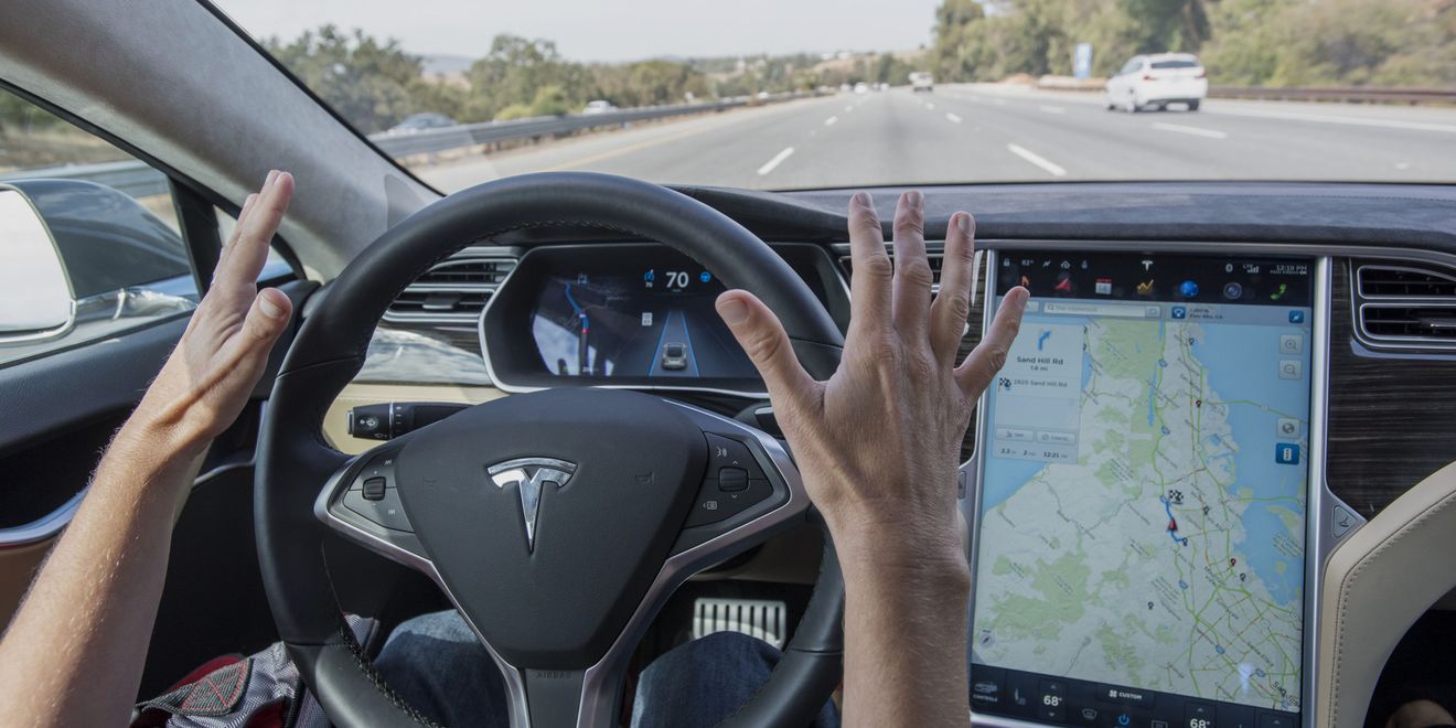 A member of the media test drives a Tesla Motors Inc. Model S car equipped with Autopilot in Palo Alto, California, U.S., on Wednesday, Oct. 14, 2015. Tesla Motors Inc. will begin rolling out the first version of its highly anticipated 