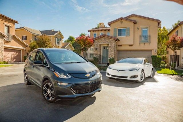 2017-chevrolet-bolt-ev-premier-vs-2016-tesla-model-s-60-front-three-quarters