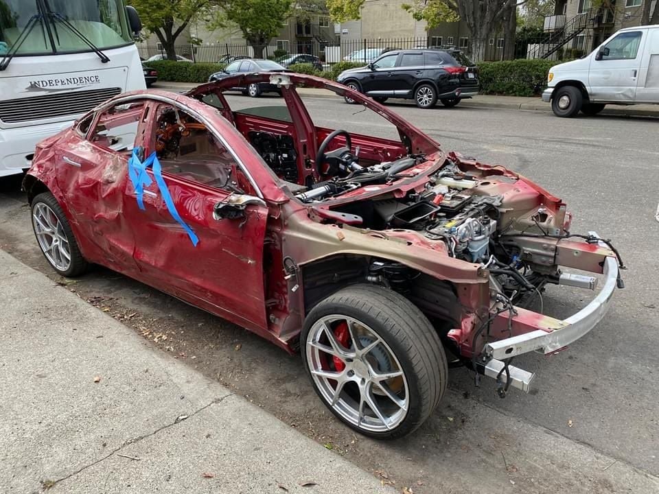 Se vende Tesla Model 3. Pintura roja personalizada, pocos kilómetros, llantas de 20 pulgadas. Necesita algo de trabajo en la chapa...